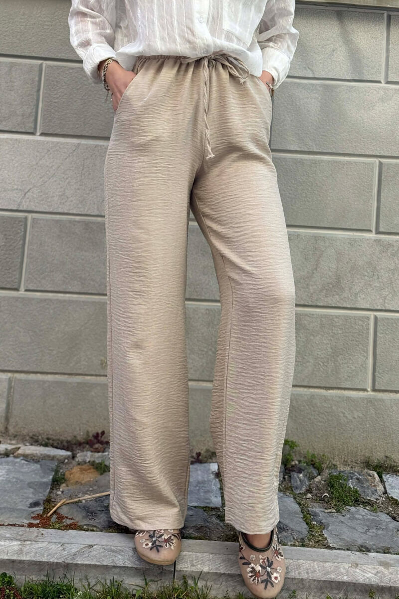 PANTALLONA ME BEL ELASTIK DHE ME DETAJIN E LIDHSEVE PER FEMRA NE NGJYRE BEZHE - 4